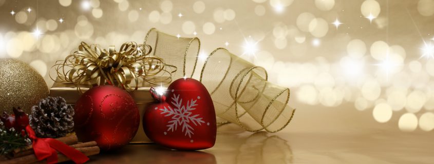 Decorative Christmas background with baubles, gifts and ribbon with bokeh lights