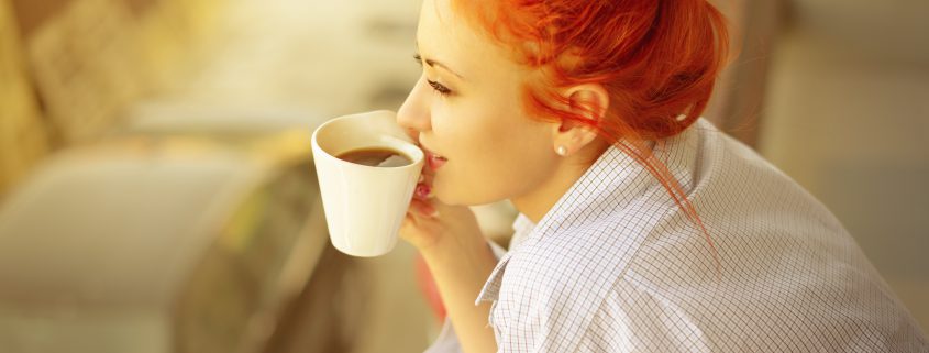 good morning womans with cup of fragrant coffee on balcony