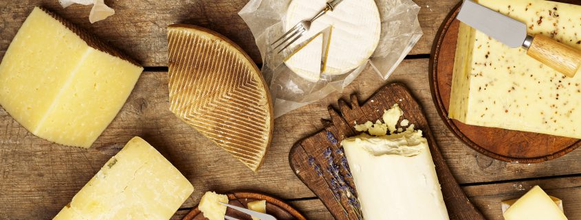 Various types of cheese on rustic background